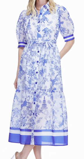 Woman wearing a blue and white floral dress with a belt on a white background