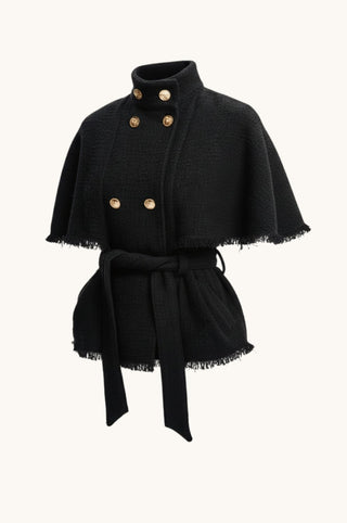 A black textured cape jacket with a high stand collar, double-breasted gold buttons, and a matching self-tie belt, shown against a plain off-white background.