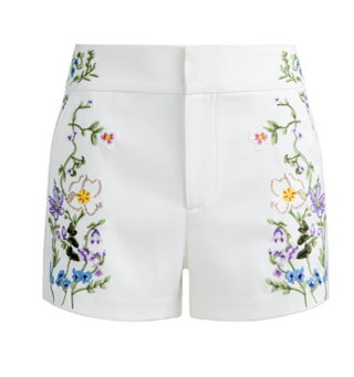 White shorts with colorful floral embroidery on a white background