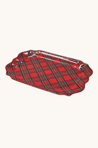 A red tartan plaid serving tray with a scalloped edge and a clear plastic handle, shown on a light cream background.