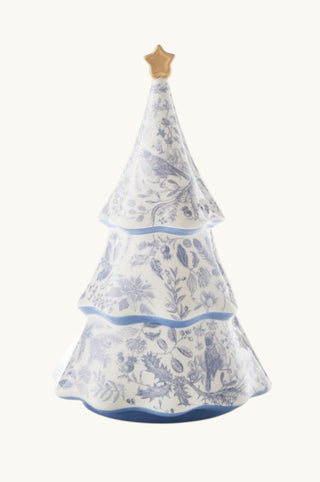 A Christmas tree-shaped ceramic container or candle holder with a blue and white toile pattern and a small gold star topper, shown against a plain off-white background.