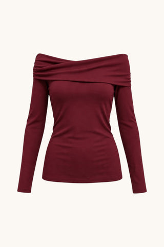 A long-sleeve off-the-shoulder knit top in deep burgundy, displayed on a clean off-white background.
