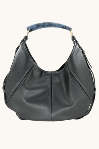A black leather hobo shoulder bag with a curved top handle featuring a blue and gray marbled pattern, set against a plain off-white background.
