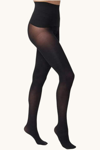 Black sheer tights worn by a model, shown from the waist down against a plain off-white background.