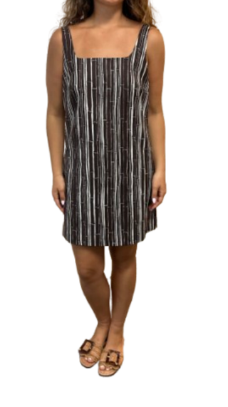 Woman wearing a black and white striped dress on a white background
