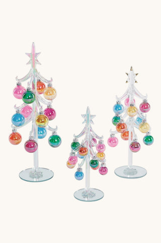 Three clear glass miniature Christmas tree ornaments with colorful hanging baubles and star toppers, displayed on a plain light beige background.