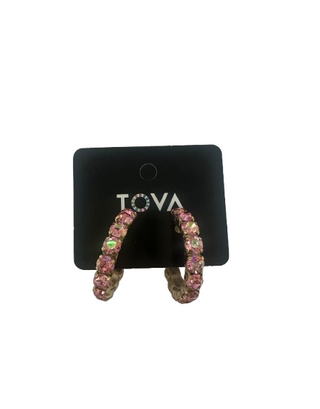 Pink hoop earrings on a black Tova branded card