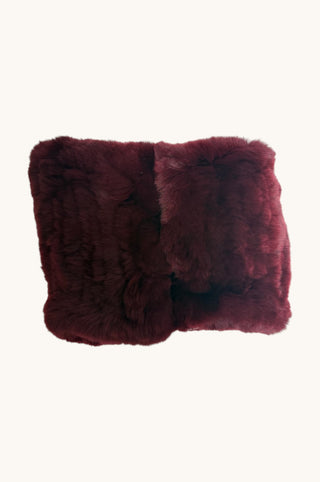 A pair of square fur handwamers in a deep burgundy color, arranged side-by-side against a plain off-white background.